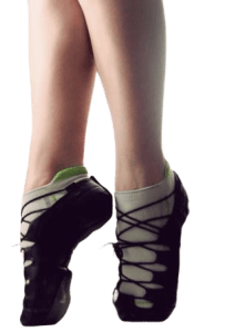 Lower leg of irish dancer showing soft dancing shoes and standing high on her toes