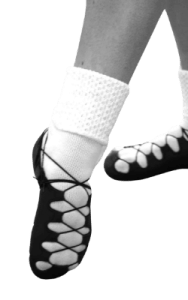 Irish dancer wearing soft shoes or ghillies and pointing toe