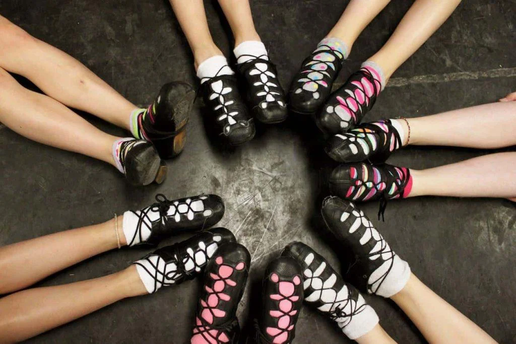 irish dancers with shoes in a circle with colorful socks