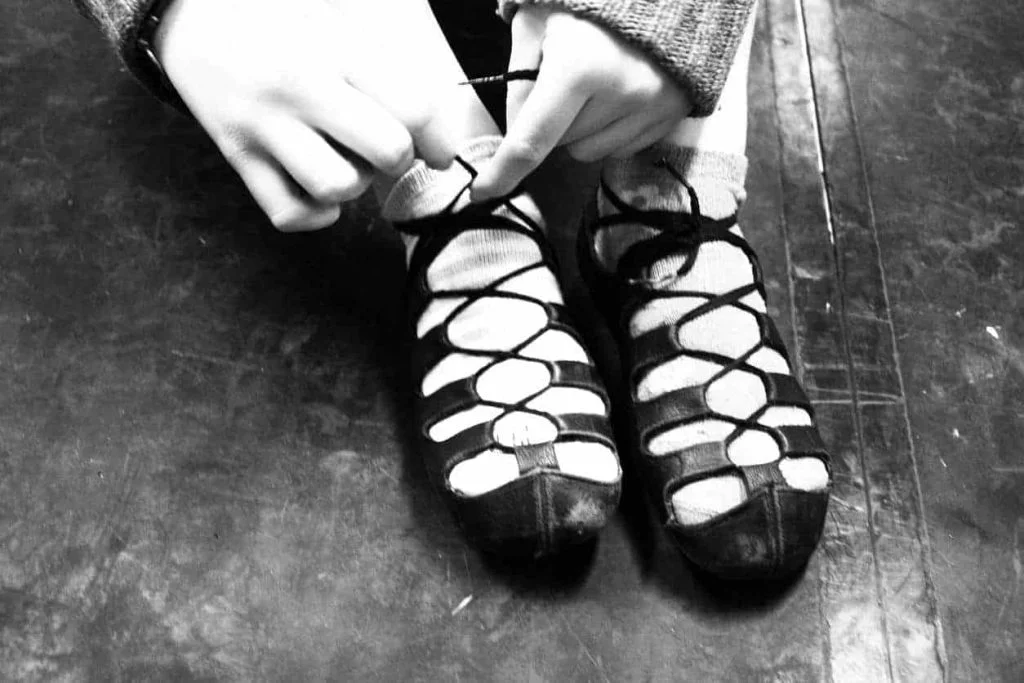 dancer putting on shoes preparing for first competition feis